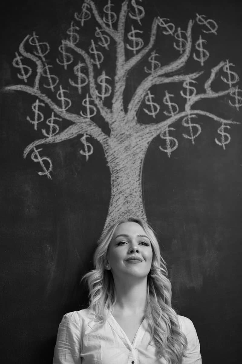 A woman smiling, where a money tree drawn on top of her